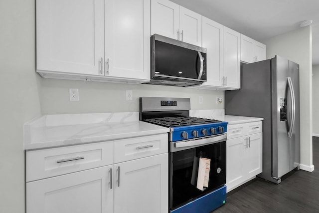 2751 Baker Ave, Cincinnati, OH 45211 - kitchen with appliances with stainless steel finishes, dark wood-style flooring, white cabinets, and light stone counters