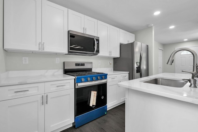 2751 Baker Ave, Cincinnati, OH 45211 - kitchen with stainless steel appliances, a sink, dark wood-style floors, white cabinetry, and recessed lighting