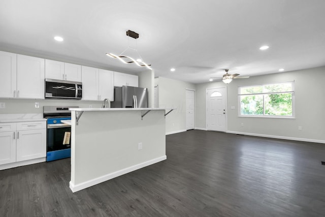 2751 Baker Ave, Cincinnati, OH 45211 - kitchen with appliances with stainless steel finishes, light countertops, white cabinetry, recessed lighting, and dark wood finished floors
