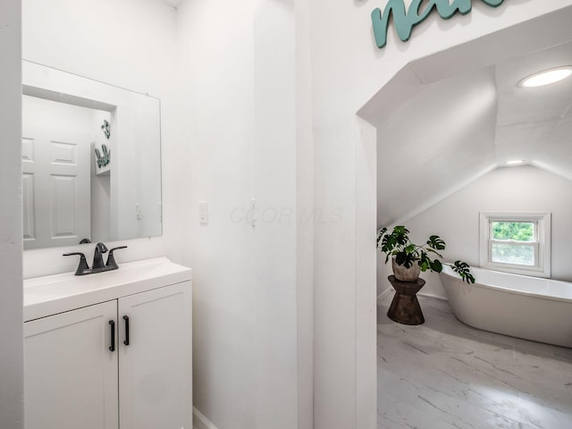 179 Boyleston Ave, Newark, OH 43055 - bathroom with vanity, lofted ceiling, a freestanding bath, and marble look tile flooring