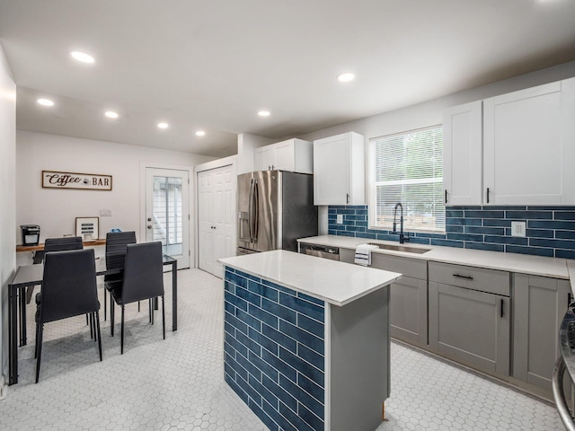 179 Boyleston Ave, Newark, OH 43055 - kitchen featuring stainless steel appliances, light countertops, a kitchen island, recessed lighting, and backsplash