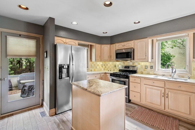 4367 Tavistock Cir, Powell, OH 43065 - kitchen with appliances with stainless steel finishes, light brown cabinets, a sink, plenty of natural light, and recessed lighting