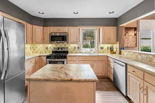 4367 Tavistock Cir, Powell, OH 43065 - kitchen with stainless steel appliances, a sink, light brown cabinets, decorative backsplash, and recessed lighting