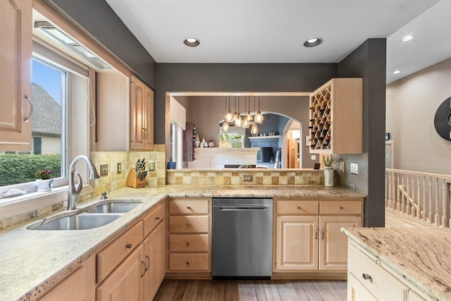 4367 Tavistock Cir, Powell, OH 43065 - kitchen featuring stainless steel dishwasher, a sink, light brown cabinetry, light wood-type flooring, and a chandelier