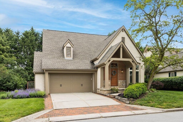 4367 Tavistock Cir, Powell, OH 43065 - view of front facade featuring roof with shingles, driveway, a front lawn, stucco siding, and a garage