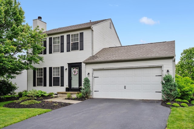 529 Durham Ln, Delaware, OH 43015 - colonial inspired home featuring driveway, a chimney, and a garage
