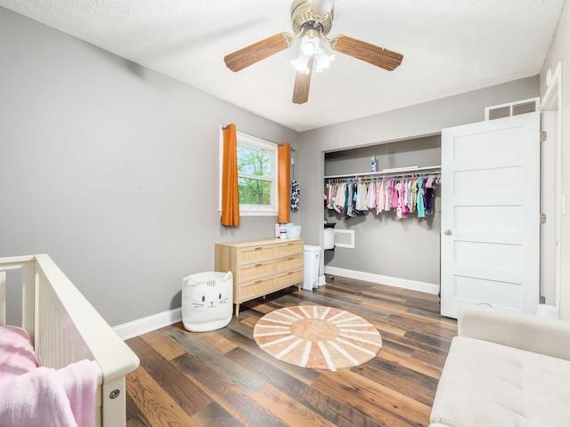7121 Briarcliff Rd, Reynoldsburg, OH 43068 - bedroom featuring dark wood-style floors, baseboards, a closet, and ceiling fan