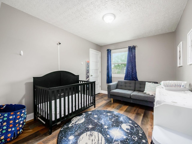 7121 Briarcliff Rd, Reynoldsburg, OH 43068 - bedroom with wood finished floors, a textured ceiling, and baseboards