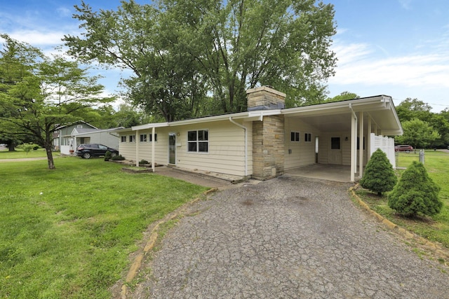 269 N 30th St, Newark, OH 43055 - view of front of property featuring driveway, a front lawn, an attached carport, and a chimney