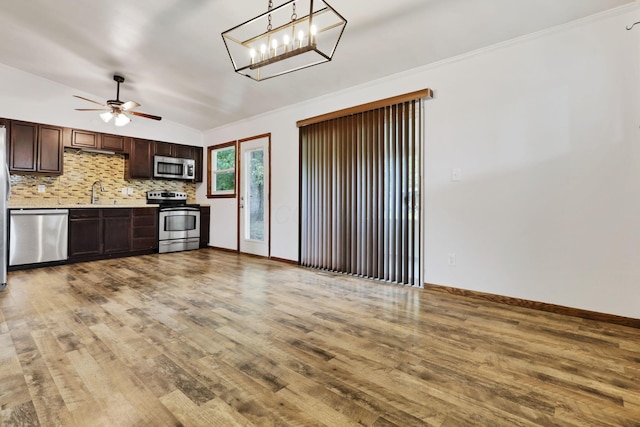 269 N 30th St, Newark, OH 43055 - kitchen with stainless steel appliances, lofted ceiling, wood finished floors, light countertops, and dark brown cabinetry