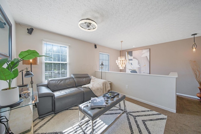 3297 Joshstock Dr Unit 3297D, Columbus, OH 43232 - carpeted living room featuring a chandelier, a textured ceiling, and baseboards