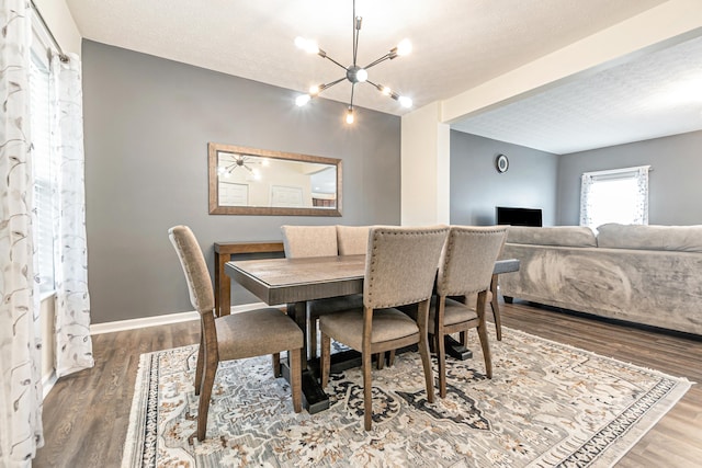 42 Carolyn Ln, Delaware, OH 43015 - dining space featuring a chandelier, wood finished floors, and a textured ceiling