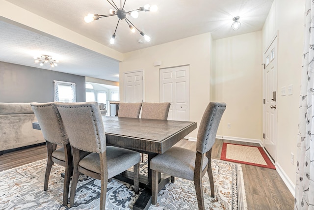 42 Carolyn Ln, Delaware, OH 43015 - dining area featuring wood finished floors, a chandelier, and baseboards