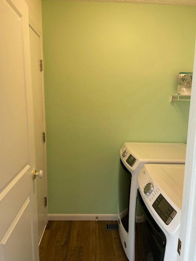 6916 Woody Ct, Canal Winchester, OH 43110 - washroom with washing machine and dryer, wood finished floors, and baseboards
