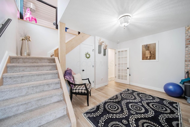 2348 Willowside Ln, Grove City, OH 43123 - stairs featuring wood finished floors, baseboards, and french doors