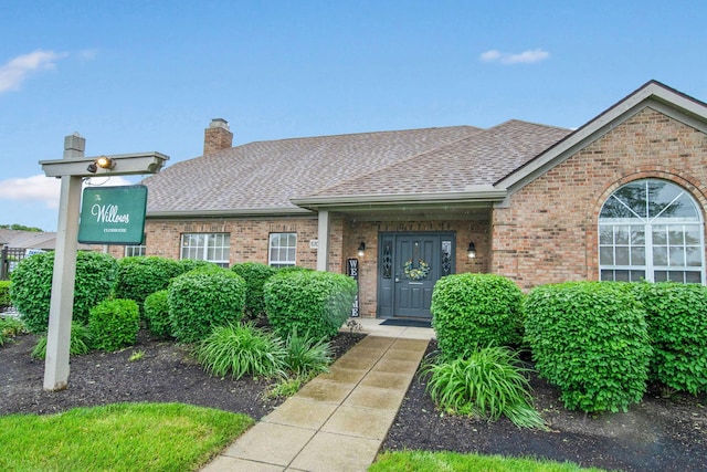 2348 Willowside Ln, Grove City, OH 43123 - view of front facade featuring a shingled roof, brick siding, and a chimney