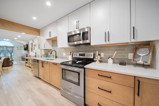 2348 Willowside Ln, Grove City, OH 43123 - kitchen featuring appliances with stainless steel finishes, tasteful backsplash, a sink, light countertops, and recessed lighting