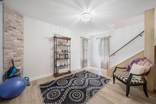 2348 Willowside Ln, Grove City, OH 43123 - sitting room with wood finished floors, stairway, a textured ceiling, baseboards, and a chandelier