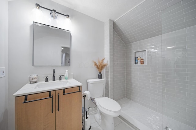 2348 Willowside Ln, Grove City, OH 43123 - bathroom featuring vanity, toilet, tiled shower, lofted ceiling, and tile patterned floors