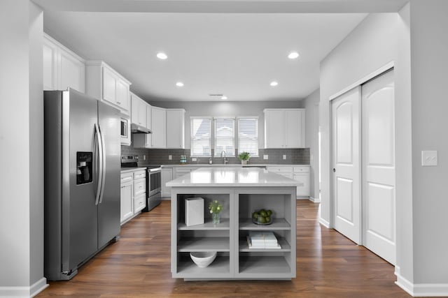 6051 Limewood Dr, Westerville, OH 43081 - kitchen with appliances with stainless steel finishes, open shelves, tasteful backsplash, white cabinetry, and recessed lighting
