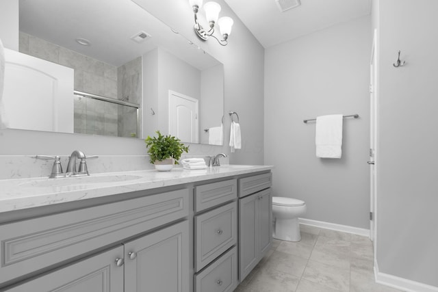6051 Limewood Dr, Westerville, OH 43081 - full bath with double vanity, a stall shower, toilet, baseboards, and marble look tile flooring