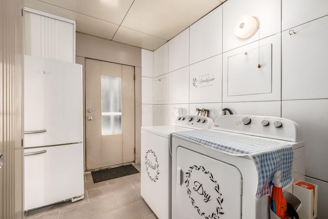 214 Arden Rd, Columbus, OH 43214 - laundry room with cabinet space, independent washer and dryer, and light tile patterned flooring