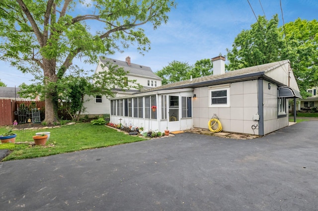 214 Arden Rd, Columbus, OH 43214 - back of house with a sunroom and a chimney