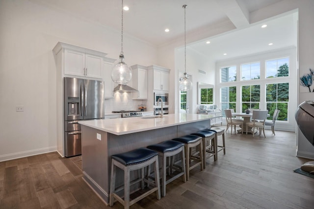 1526 Villa Way, Powell, OH 43065 - kitchen with appliances with stainless steel finishes, crown molding, an island with sink, white cabinets, and light countertops