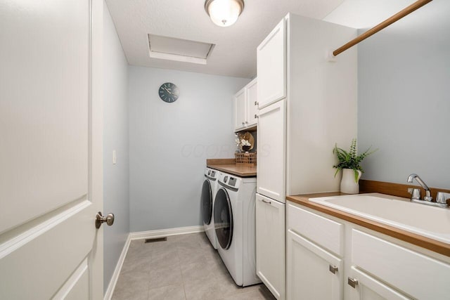 7306 Whimbrel Ln, Sunbury, OH 43074 - laundry area featuring cabinet space, washer and dryer, baseboards, and attic access