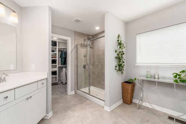 7306 Whimbrel Ln, Sunbury, OH 43074 - bathroom featuring a shower stall, baseboards, a walk in closet, vanity, and recessed lighting