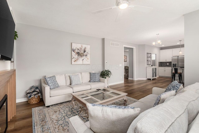 7306 Whimbrel Ln, Sunbury, OH 43074 - living area with baseboards, a chandelier, dark wood-style flooring, and ceiling fan