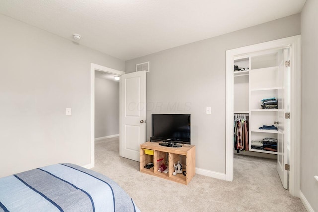 7306 Whimbrel Ln, Sunbury, OH 43074 - bedroom with light colored carpet, a walk in closet, a closet, and baseboards
