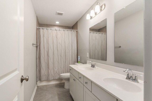 7306 Whimbrel Ln, Sunbury, OH 43074 - bathroom featuring double vanity, toilet, baseboards, and tile patterned floors