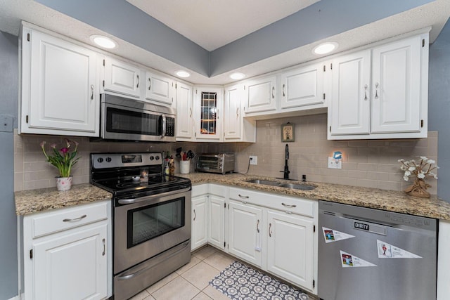 1392 Brenthaven Pl, Columbus, OH 43228 - kitchen with appliances with stainless steel finishes, a sink, white cabinetry, backsplash, and recessed lighting