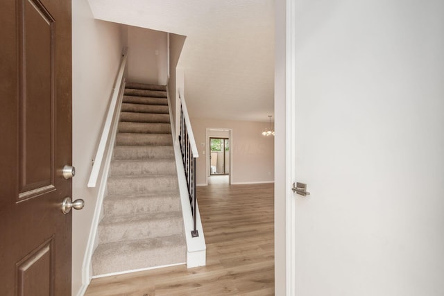 2353 Mccauley Ct Unit 6, Columbus, OH 43220 - stairs with wood finished floors, baseboards, and a chandelier