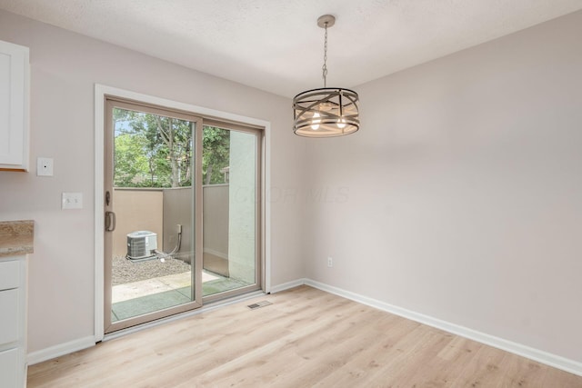2353 Mccauley Ct Unit 6, Columbus, OH 43220 - unfurnished dining area featuring light wood finished floors, a chandelier, and baseboards