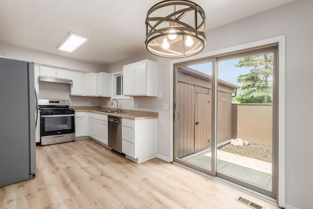 2353 Mccauley Ct Unit 6, Columbus, OH 43220 - kitchen featuring appliances with stainless steel finishes, under cabinet range hood, a sink, and light wood-style flooring