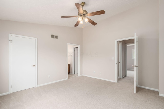 2353 Mccauley Ct Unit 6, Columbus, OH 43220 - unfurnished bedroom featuring lofted ceiling, light carpet, baseboards, connected bathroom, and a ceiling fan
