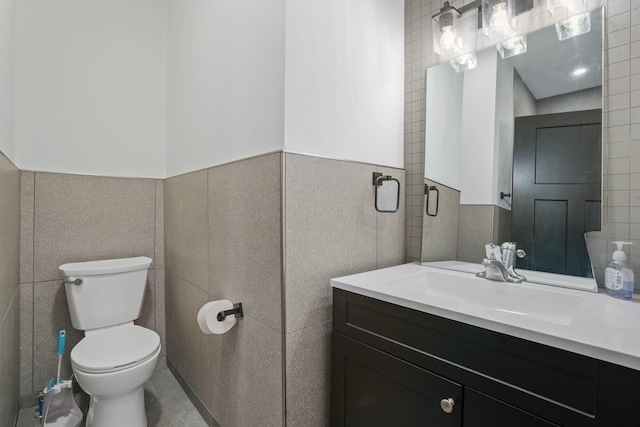 2278 Ridgeway Ave, Columbus, OH 43219 - bathroom with tile walls, vanity, toilet, and a wainscoted wall