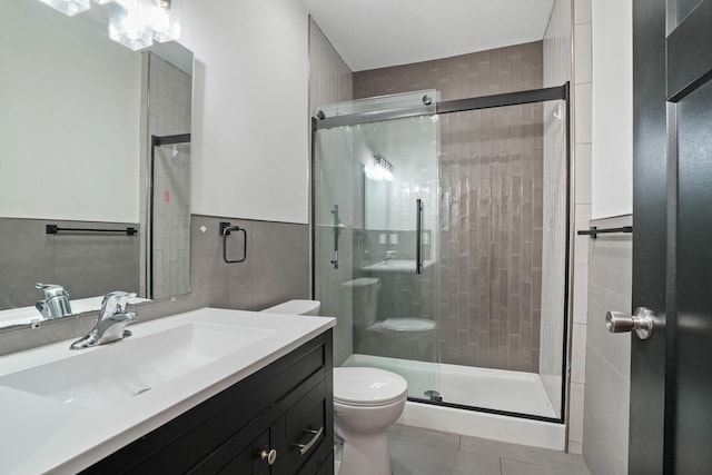 2278 Ridgeway Ave, Columbus, OH 43219 - full bathroom with tile walls, toilet, tile patterned floors, vanity, and a shower stall