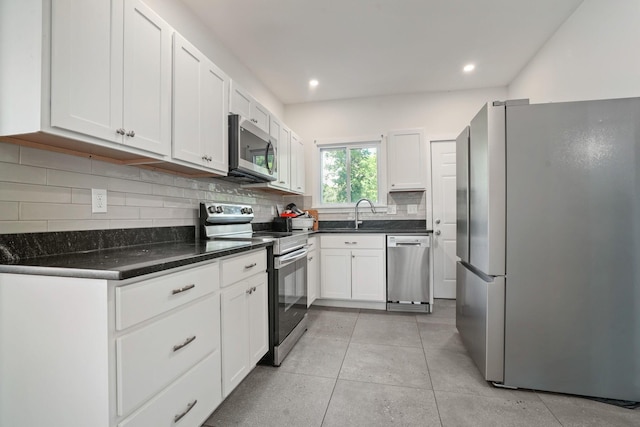2278 Ridgeway Ave, Columbus, OH 43219 - kitchen featuring stainless steel appliances, white cabinetry, decorative backsplash, recessed lighting, and a sink