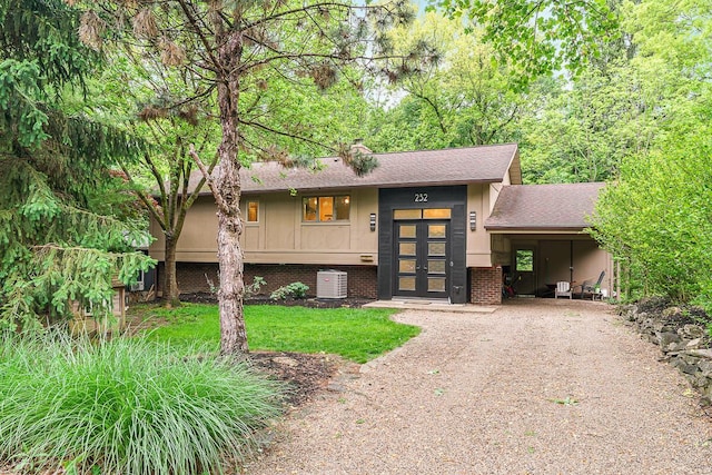 232 Hardy Way, Worthington, OH 43085 - view of front of property with roof with shingles, dirt driveway, french doors, and central AC unit
