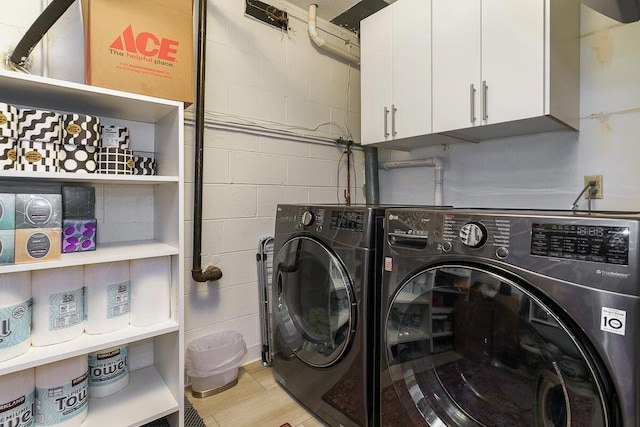 232 Hardy Way, Worthington, OH 43085 - laundry area featuring separate washer and dryer, cabinet space, and concrete block wall