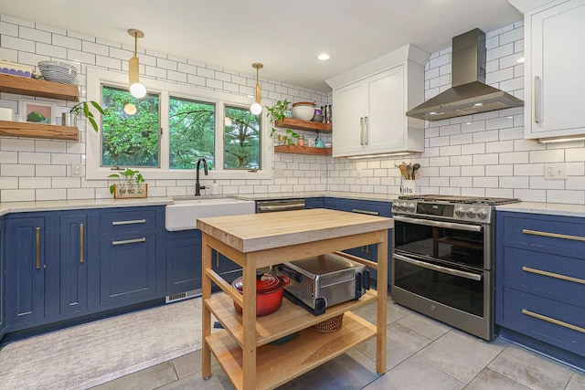 232 Hardy Way, Worthington, OH 43085 - kitchen with open shelves, wall chimney exhaust hood, blue cabinetry, range with two ovens, and recessed lighting