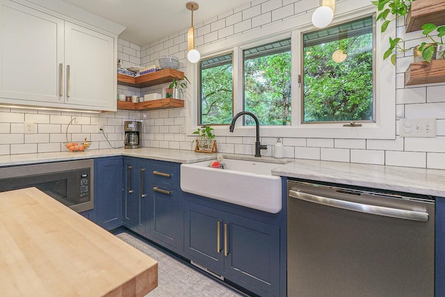 232 Hardy Way, Worthington, OH 43085 - kitchen featuring dishwasher, built in microwave, open shelves, and blue cabinetry