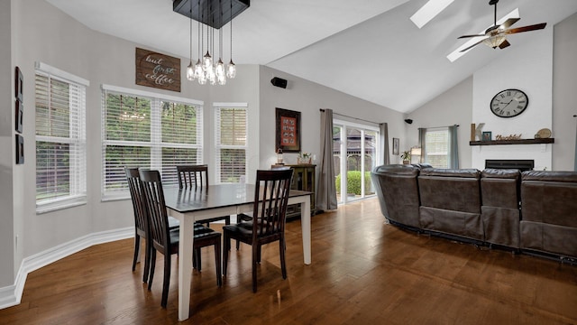 6101 Parkmeadow Ln, Hilliard, OH 43026 - dining room with a fireplace, ceiling fan, wood finished floors, high vaulted ceiling, and baseboards