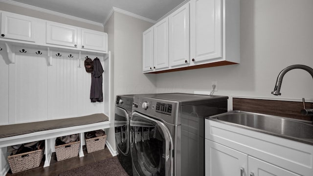 6101 Parkmeadow Ln, Hilliard, OH 43026 - laundry area with washing machine and clothes dryer, cabinet space, crown molding, and tile patterned floors