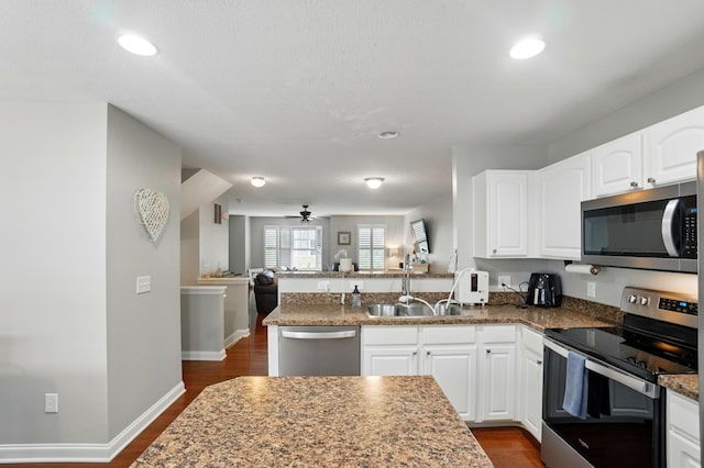 5932 Winberry Creek Dr Unit 1106, Dublin, OH 43016 - kitchen with stainless steel appliances, a sink, open floor plan, white cabinetry, and dark stone countertops
