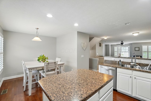 5932 Winberry Creek Dr Unit 1106, Dublin, OH 43016 - kitchen featuring dishwasher, a sink, a center island, dark wood-style flooring, and a ceiling fan