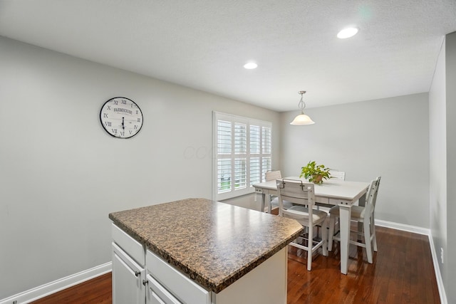 5932 Winberry Creek Dr Unit 1106, Dublin, OH 43016 - kitchen featuring baseboards, dark wood-style floors, recessed lighting, dark countertops, and a kitchen island
